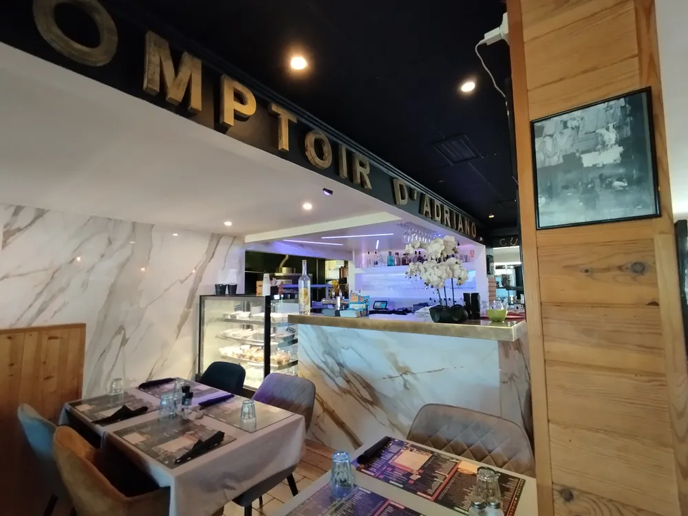 Modern white marble counter of a campsite restaurant with careful lighting and set tables