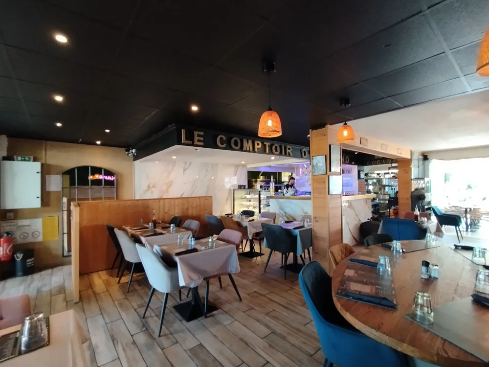 Bright interior of a campsite restaurant with a view of set tables and the bar